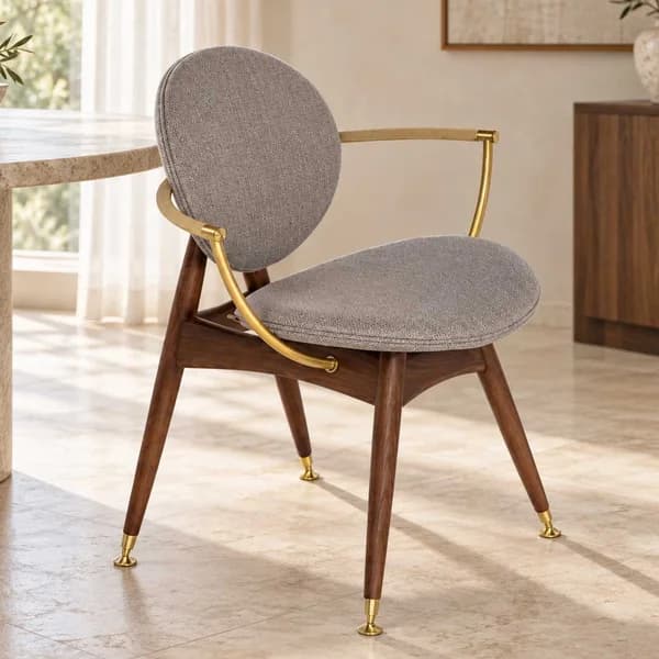 Dining chair with a sculptural round shape, wood legs, brass details, and rope-wrapped arms, where modern comfort meets timeless elegance. Luxury dining chair in Dubai UAE 