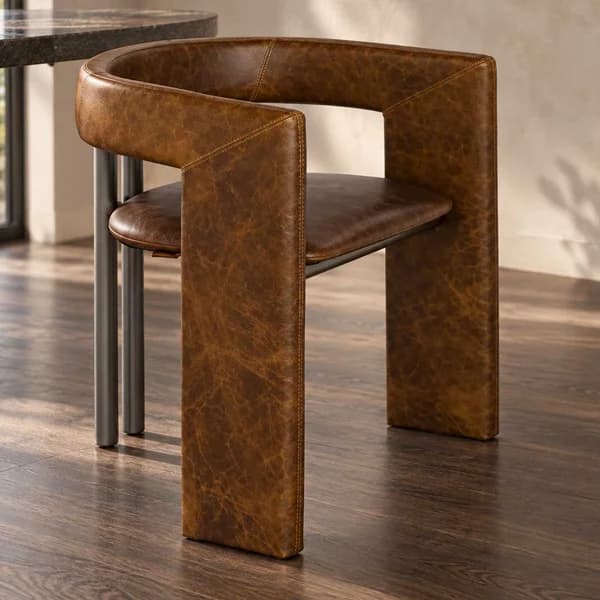 Verde Terra Dining Chair Luxury dining chair with curved design, upholstered in rich brown genuine leather and supported by polished stainless steel legs.