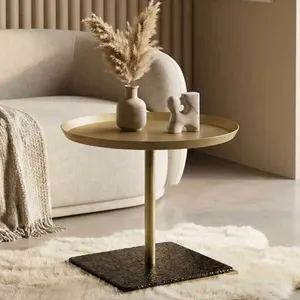 A sleek side table crafted from brass-finish metal and frosted glass.