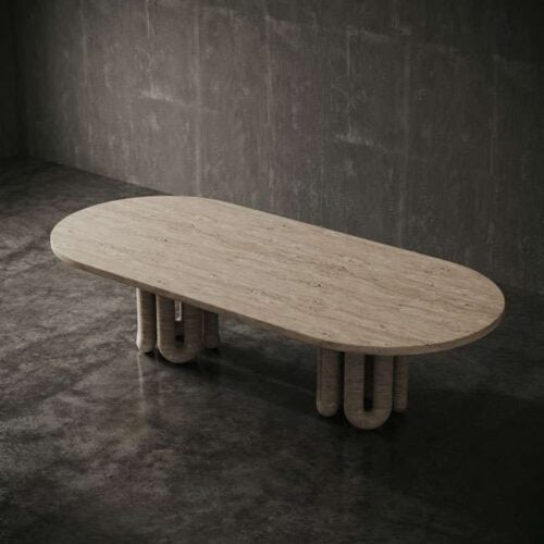 Modern oval dining table made from Turkish beige travertine with sculptural legs – luxury furniture piece for UAE interiors. طاولة طعام بيضاوية حديثة مصنوعة من ترافرتين تركي بيج مع أرجل نحتية - قطعة أثاث فاخرة للديكورات الداخلية في الإمارات.