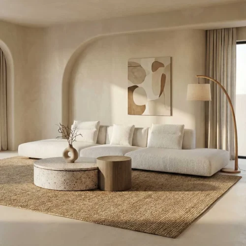 Luxury modern living room furniture in Dubai and Abu Dhabi featuring an elegant designer sofa paired with a refined travertine coffee table, showcasing natural stone materials, premium craftsmanship, and sophisticated contemporary interior styling for upscale homes