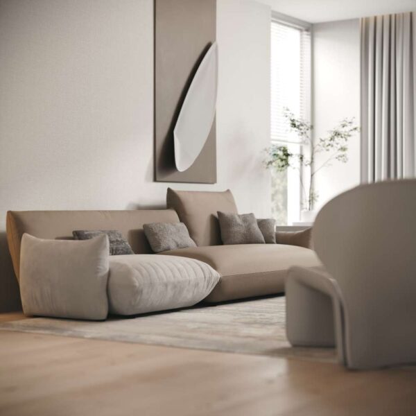 Side angle of Dune Harmony Sofa with neutral cushions and artistic wall décor – luxury modular seating for UAE homes. منظر جانبي لكنبة ديون هارموني مع وسائد حيادية ولوحة فنية – مقعد فاخر بتصميم وحدات للمنازل الإماراتية.