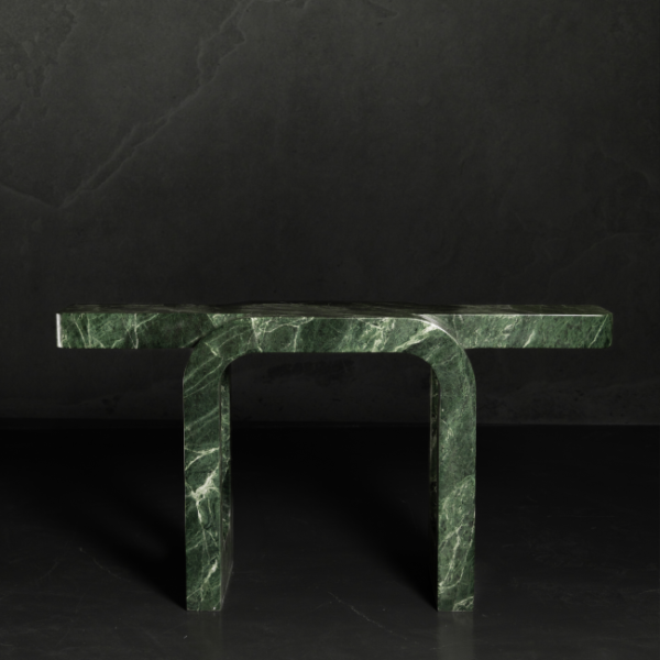 Front view of sculptural green marble console table with U-shaped legs – bold luxury accent piece for contemporary interiors in the UAE. عرض أمامي لطاولة كونصول فاخرة من الرخام الأخضر بأرجل على شكل حرف U – قطعة مميزة تناسب التصاميم الداخلية العصرية في الإمارات. Close-up of rich green marble texture with natural white veining – premium stone detail of a luxury console table, perfect for high-end interiors in the UAE. صورة مقربة لتفاصيل رخام أخضر فاخر مع عروق بيضاء طبيعية – حجر فاخر لتصميم طاولة كونصول أنيقة تناسب المساحات الراقية في الإمارات.