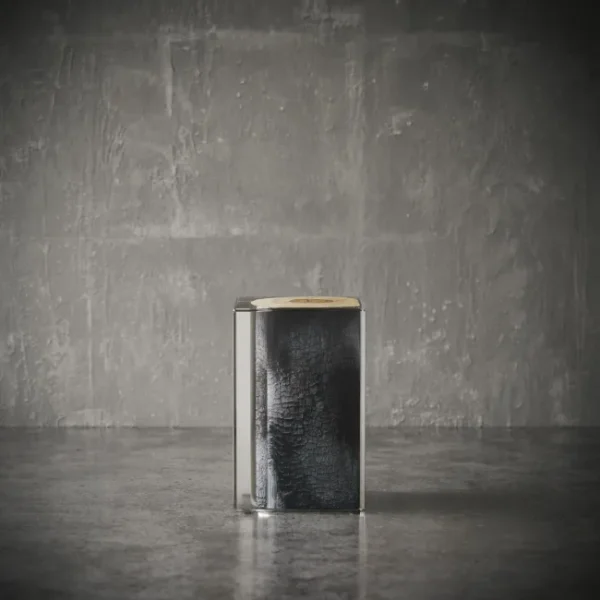 Ember side table in a minimalist setting, showcasing a charred wood core inside a transparent acrylic cube – modern UAE luxury furniture طاولة جانبية من طراز إمبر بتصميم مكعب في بيئة بسيطة، نواة خشبية محترقة داخل هيكل أكريليك شفاف – أثاث فاخر عصري في الإمارات