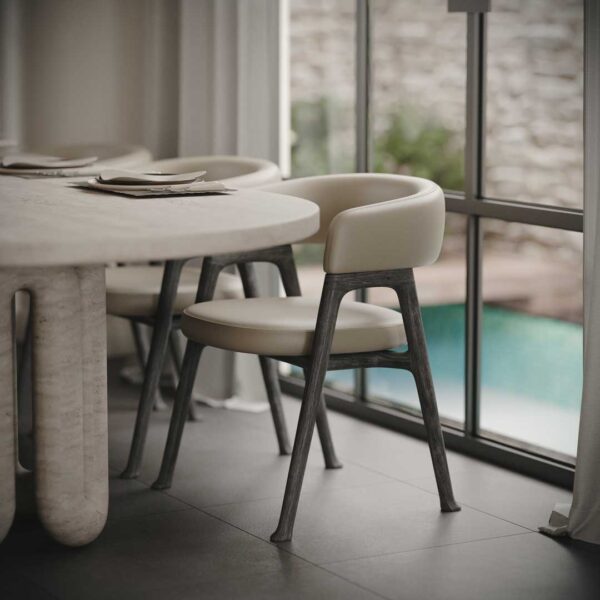 Luxury dining table with sculptural marble base and premium upholstered dining chairs featuring curved backrests and solid wood legs by Conceptual. This high-end dining set blends modern elegance with exceptional comfort, ideal for homeowners, interior designers, and property developers searching for luxury dining chairs and dining tables in Dubai, Abu Dhabi, and across the UAE.