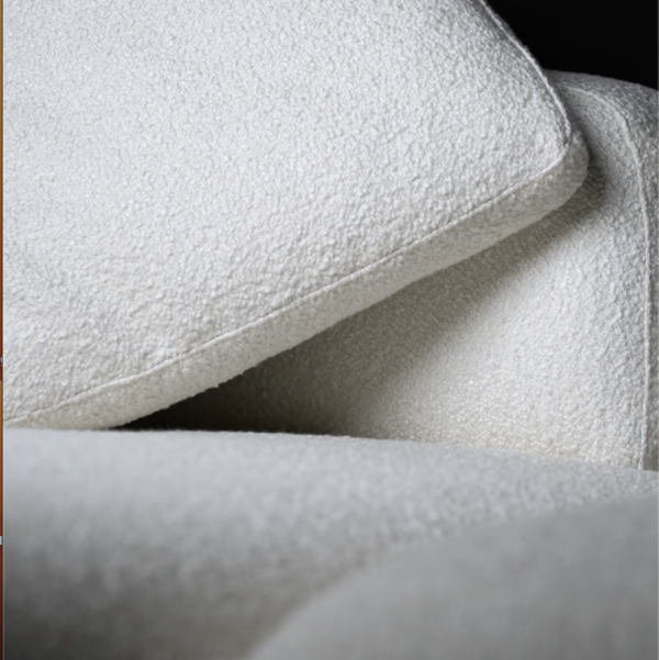 Close-up view of Sereno Sand Sofa fabric, showcasing its soft and textured boucle upholstery. صورة مقرّبة لقماش كنبة سيرينو ساند تُبرز التنجيد الناعم والمحبب من قماش البوكلية