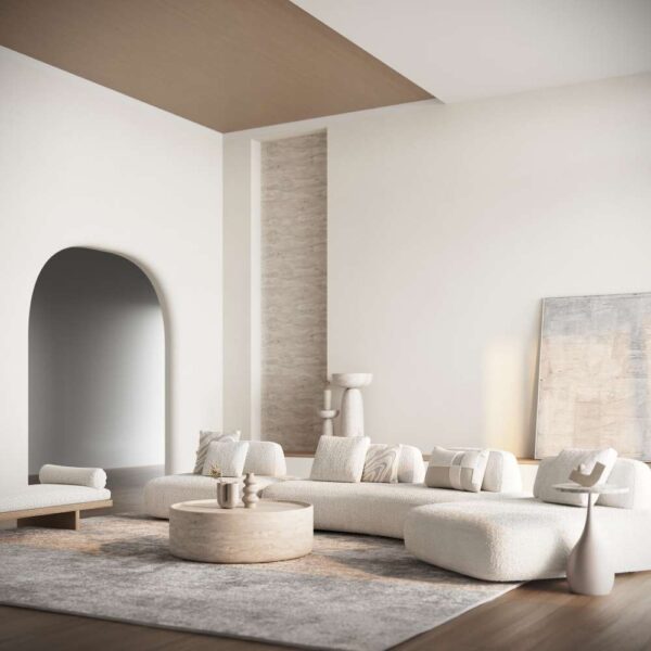 Angle view of Sereno Sand Sofa in a modern interior, styled with soft lighting and sculptural decor pieces. منظر بزاوية لكنبة سيرينو ساند ضمن ديكور داخلي عصري، مزينة بإضاءة ناعمة وقطع ديكور فنية.