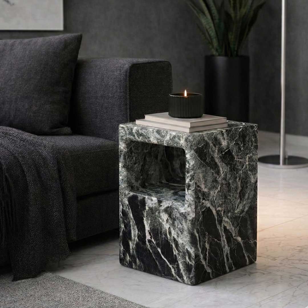 Verdura Side Table carved from solid green marble, featuring a geometric cuboid form with open shelves on both sides. The natural marble veins in shades of deep green, black, and white create a bold, luxurious statement.