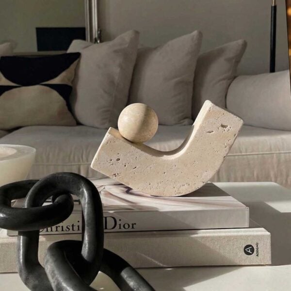 Luxury travertine stone sculpture accessory in UAE – modern beige decorative piece with unique curved design and sphere accent إكسسوار فاخر من حجر الترافرتين – قطعة ديكور حديثة باللون البيج بتصميم منحني مع كرة زخرفية Dior