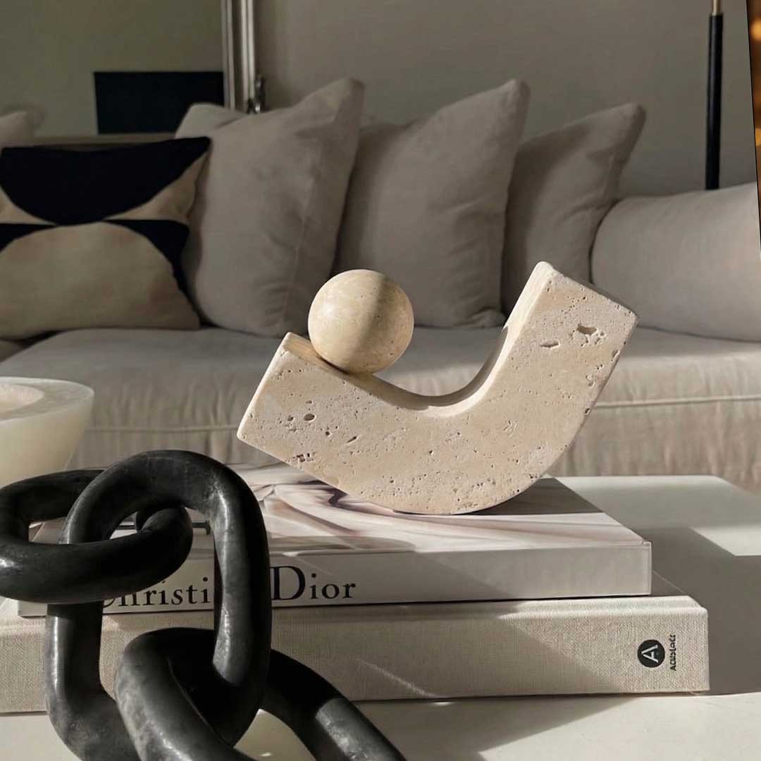 Luxury travertine stone sculpture accessory in UAE – modern beige decorative piece with unique curved design and sphere accent إكسسوار فاخر من حجر الترافرتين – قطعة ديكور حديثة باللون البيج بتصميم منحني مع كرة زخرفية Dior