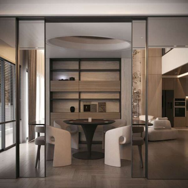 Minimalist dining room in Dubai featuring sculptural beige chairs and round black base table غرفة طعام بسيطة في دبي بتصميم نحتي يضم كراسي بيج وطاولة بقاعدة سوداء