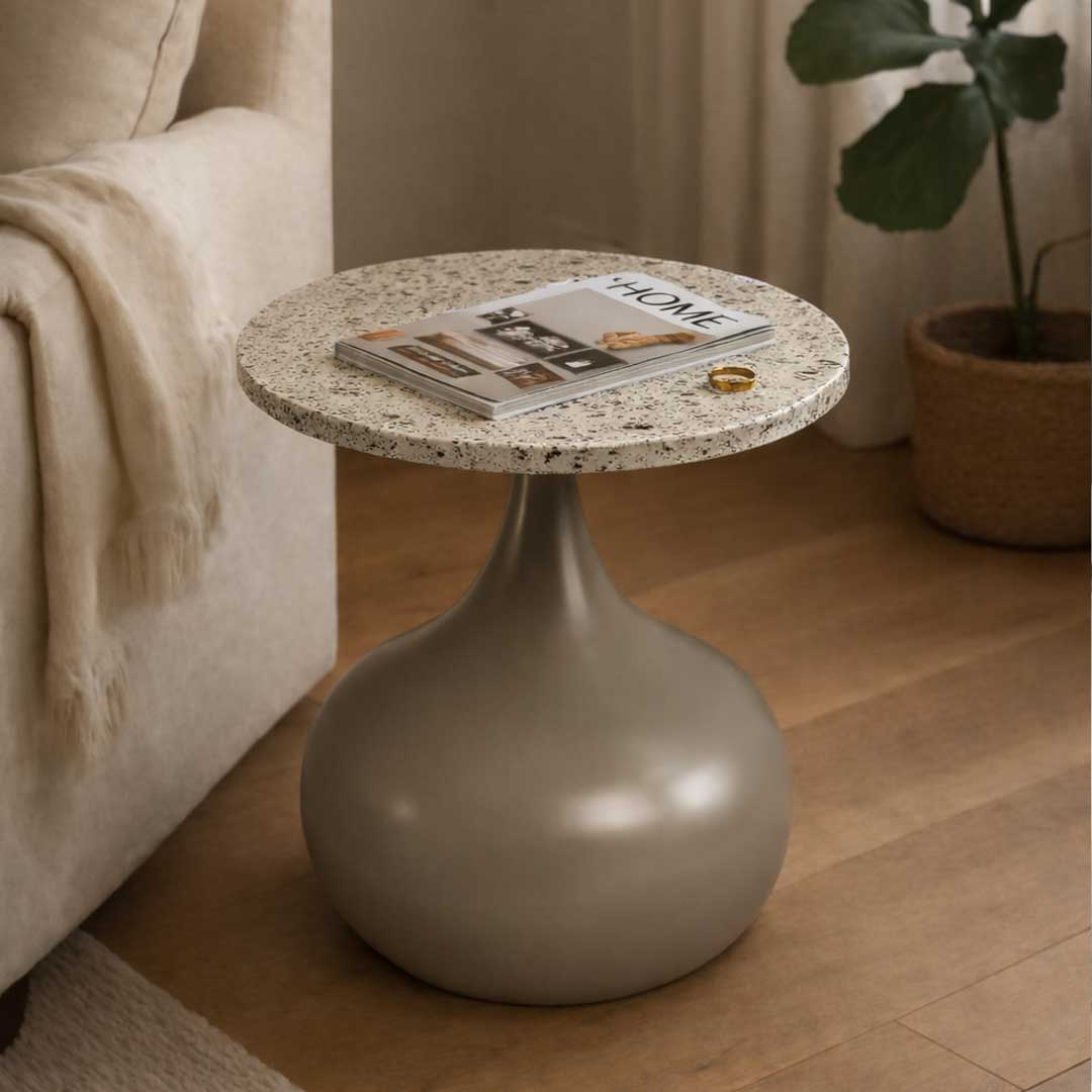 The Elara Bold Side Table features a sculptural teardrop-shaped base in a smooth matte finish paired with a circular terrazzo top. Its organic curves and minimalist geometry create a statement of modern elegance.