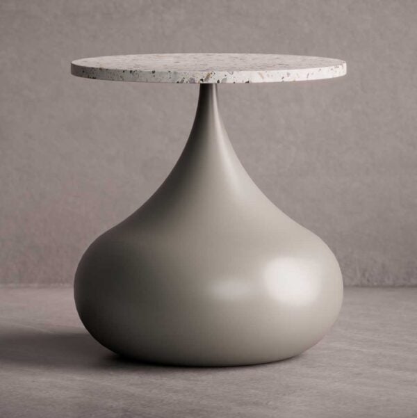 The Elara Bold Side Table features a sculptural teardrop-shaped base in a smooth matte finish paired with a circular terrazzo top. Its organic curves and minimalist geometry create a statement of modern elegance.