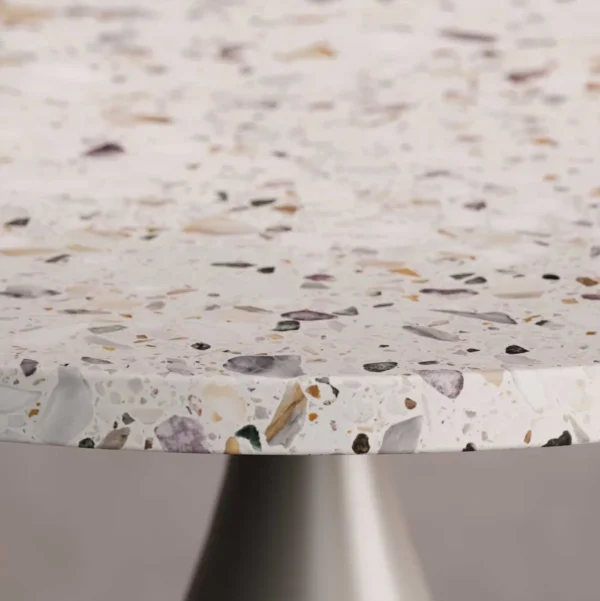 A close-up of the Elara Bold Side Table’s terrazzo top, showcasing a smooth surface with embedded multicolored stone fragments in warm and cool tones. The refined detailing highlights the table’s artisanal craftsmanship.