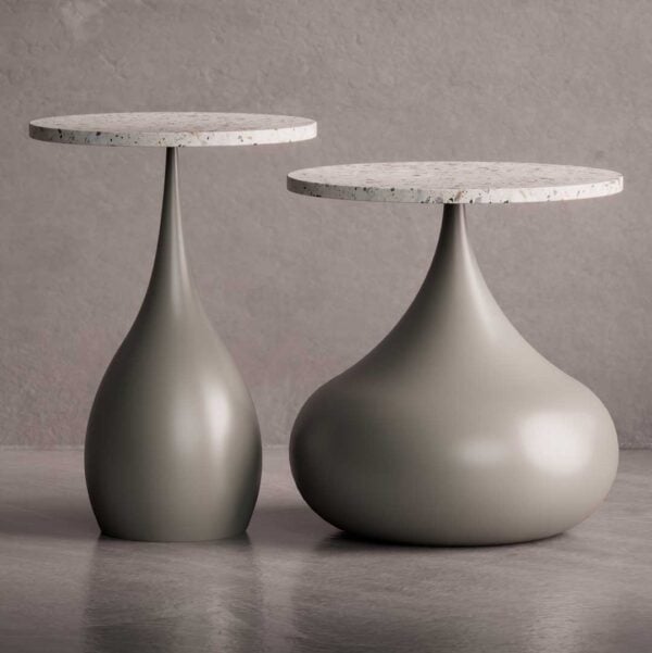 The Elara Side Table Collection features two versions: Elara Bold and Elara Slim. Both have rounded, sculptural bases with smooth matte finishes and terrazzo tops. Displayed side by side, they show a balance between volume and elegance.