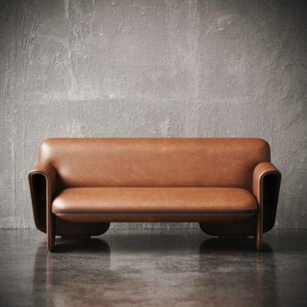 Front view of Montoro Sofa against a concrete wall for product display. لقطة أمامية لكنبة مونتورو أمام جدار خرساني لأغراض عرض المنتج
