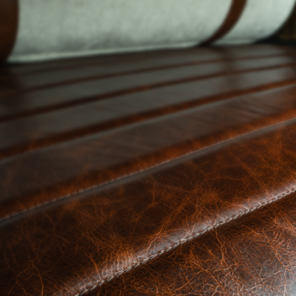 Textured genuine leather seat surface with stitched horizontal panels – refined craftsmanship for luxury conceptual seating. سطح مقعد من الجلد الطبيعي بتفاصيل خياطة أفقية – إتقان في التصميم لكرسي فاخر مفاهيمي.