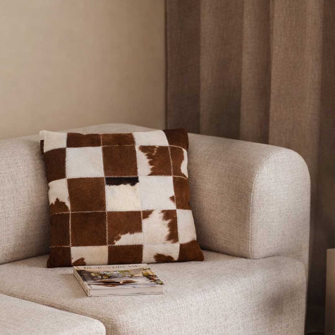 Rustic Patchwork Cushion 45x45 cm – luxury square cushion made from horsehair and leather in natural brown and white patchwork design, premium home décor accessory in UAE وسادة بروسك باتشوورك مربعة 45×45 سم – وسادة فاخرة مصنوعة من شعر الخيل والجلد الطبيعي بتصميم باتشوورك بني وأبيض، إكسسوار ديكور فاخر في الإمارات."