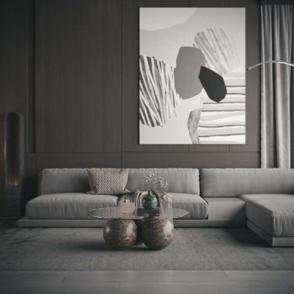 Modern living room featuring Eclipse coffee table with sculptural marble ball legs and glass top beneath a statement art piece. غرفة معيشة عصرية تحتوي على طاولة قهوة إكليبس بأرجل رخامية كروية وسطح زجاجي تحت لوحة فنية مميزة.