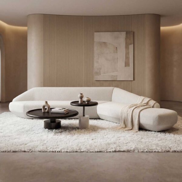 Luxury minimalist coffee table in a modern Dubai living room, featuring a round wooden design with sculpted legs, styled with elegant décor and surrounded by premium contemporary furniture in neutral tones.