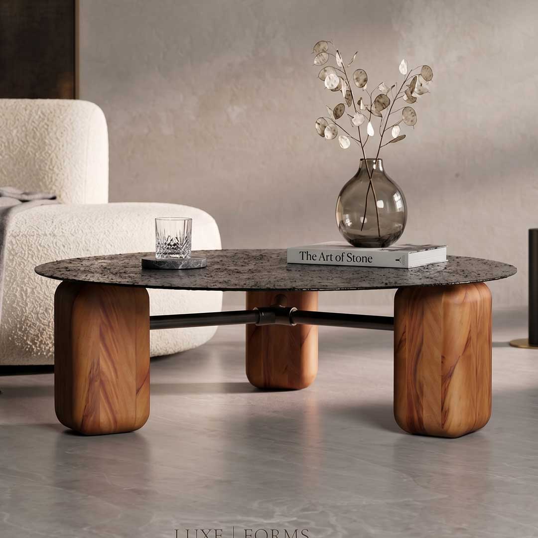 Elegant Mavri Coffee Table with a round black textured top and smooth wooden cylindrical legs, a statement luxury furniture piece available in Dubai and Abu Dhabi, UAE.