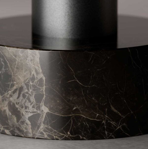 A close-up of the Nocturne Coffee Table base, showing polished dark marble with fine natural veining and a sleek matte black metal support above. The image highlights the table’s luxurious craftsmanship and refined material harmony.