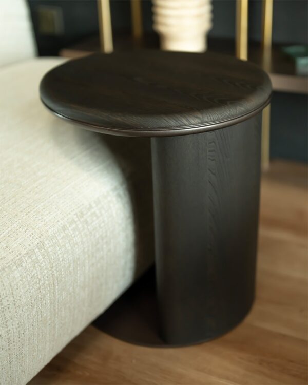 Close-up of the CaffeLinea Side Table showcasing its smooth rounded tabletop and rich dark wood grain. The elegant curvature and refined finish emphasize the table’s minimalist yet warm aesthetic.