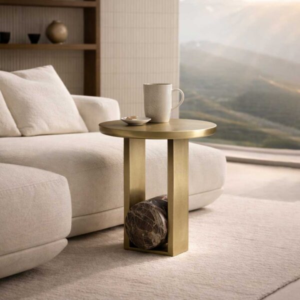 Luxury modern side table with a sculptural round top and dual vertical brass columns, featuring a solid black marble cylindrical base accent, crafted from premium metal and natural stone—designer side table for high-end interiors in Dubai and Abu Dhabi, UAE