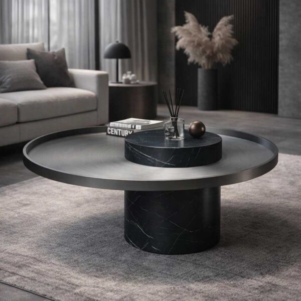 Single Bravura Gemina Coffee Table with a dark marble cylindrical base and a brushed metal circular top. The design showcases clean geometry and luxurious materials.