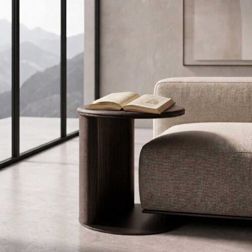 CaffeLinea Side Table featuring a minimalist cylindrical design with a curved wooden panel and circular tabletop. The smooth grain of the dark wood contrasts elegantly with the matte metal base, creating a refined, modern look.