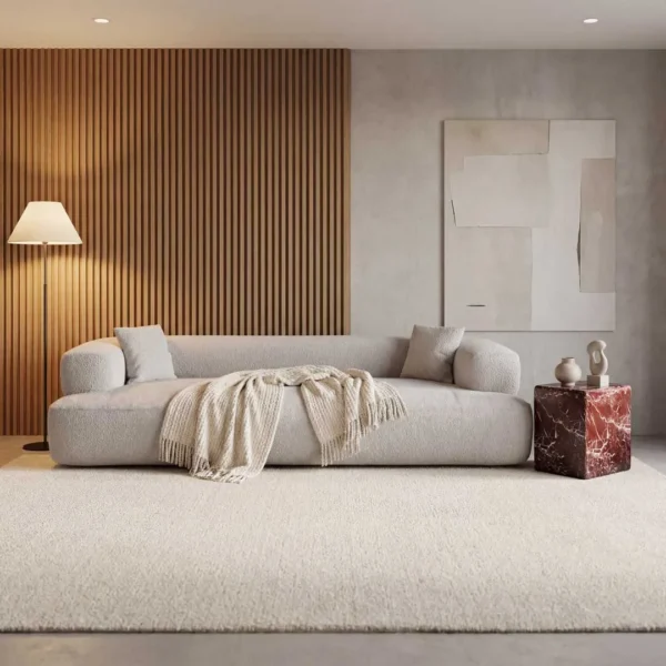 Luxury modern sofa paired with a statement marble side table, featuring a plush contemporary sofa and a sculptural stone accent table, showcasing high-end designer furniture for elegant living room interiors in Dubai and Abu Dhabi, UAE.