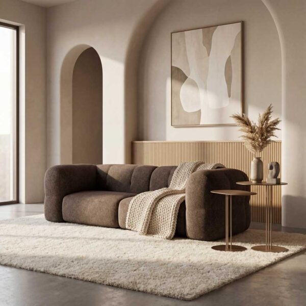 Luxury upholstered sofa paired with elegant brass side tables in a modern living room, showcasing premium contemporary furniture design for homes in Dubai and Abu Dhabi.