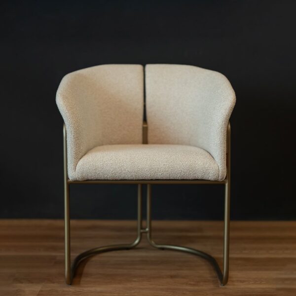 Front view of the Alvera Dining Chair highlighting its soft cream boucle fabric, contemporary brass frame, and enveloping backrest for luxurious comfort.