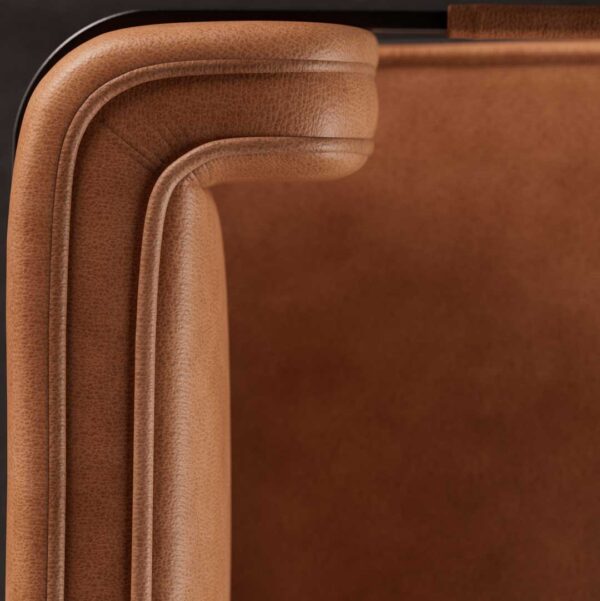 Close-up of the Ironhide Dining Chair’s tan leather upholstery, highlighting the fine grain texture, detailed stitching, and premium craftsmanship.