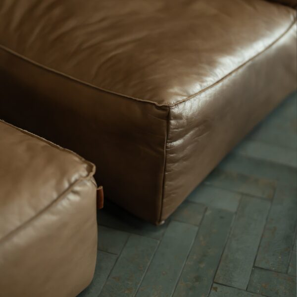 Close-up detail of Molaro Lounge Chair in reddish brown buffalo leather, highlighting premium texture and craftsmanship for UAE luxury homes
