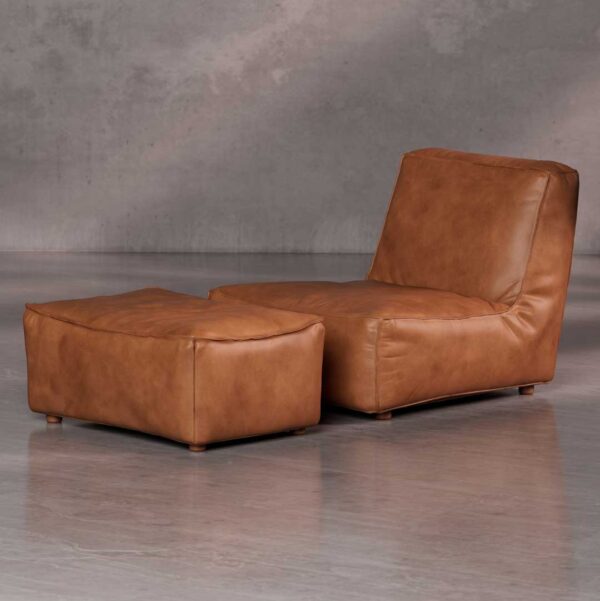 Molaro Sofa a luxurious modern lounge chair and ottoman set in rich tan leather with a low, relaxed profile, designed for premium comfort and contemporary interiors in Dubai and Abu Dhabi.