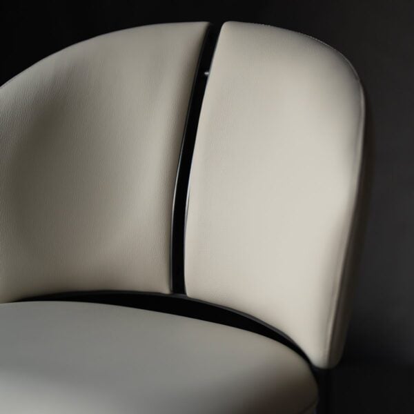A luxurious off white dining chair in microfiber leather and steel , where comfort meets modern design. كرسي طعام من الجلد المايكروفايبر مع أرجل فولاذية مصقولة بلون أبيض أنيق.