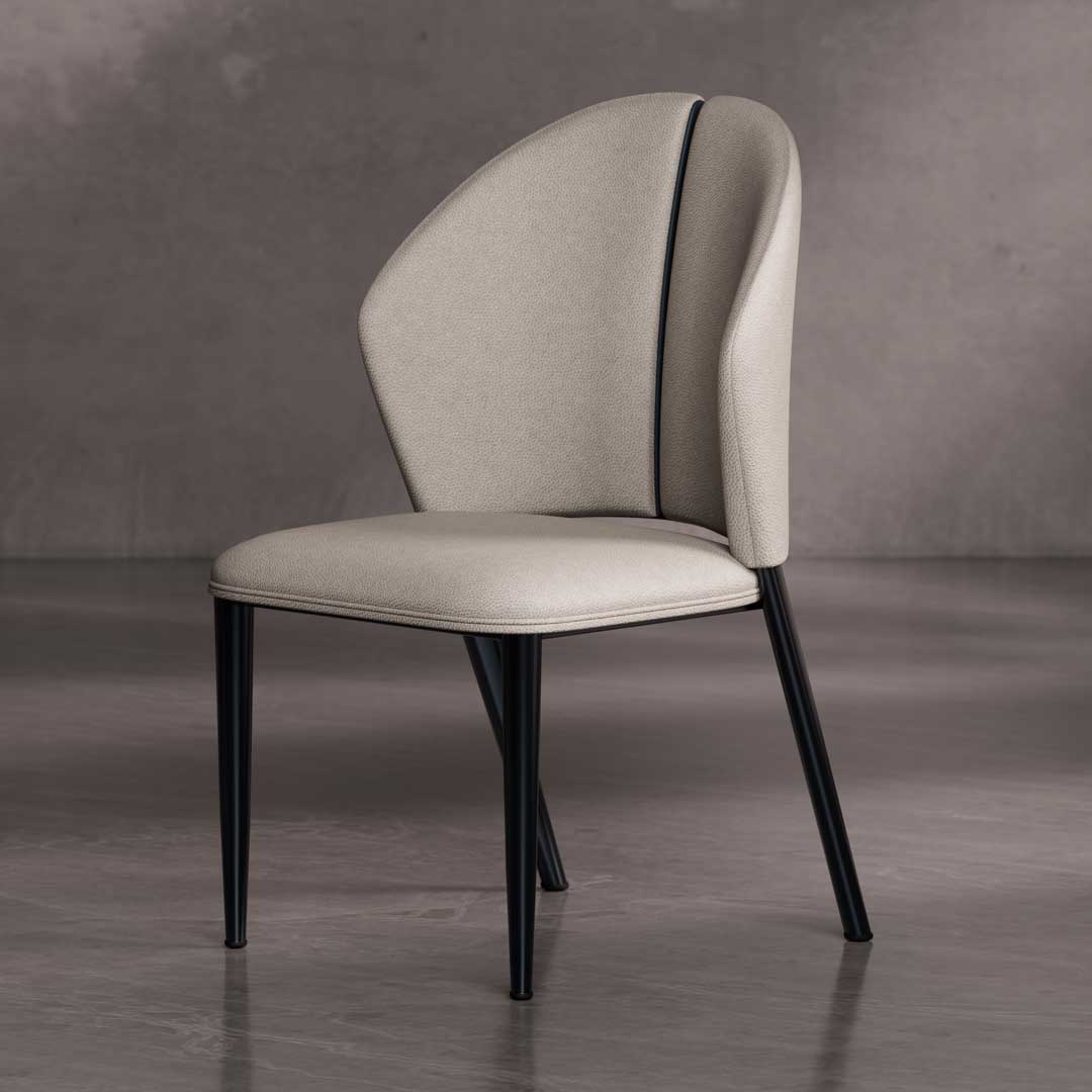 Ovara Dining Chair — a contemporary designer dining chair featuring a sculpted backrest with soft beige upholstery and sleek black tapered legs, perfect for elegant dining spaces in Dubai and Abu Dhabi.