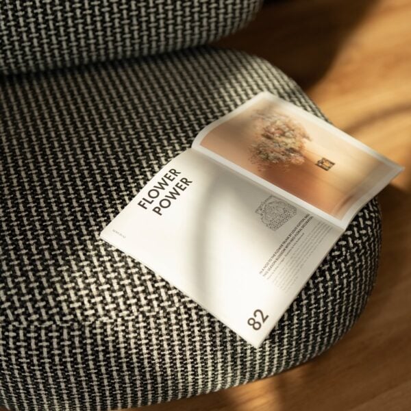 The Selden Lounge Chair styled in a modern interior with warm lighting, highlighting its soft textured fabric and minimalist design