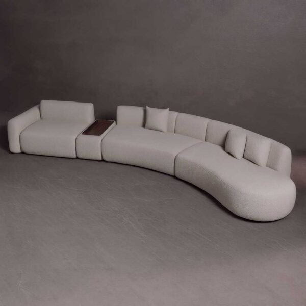 Skaya modular curved sofa in off-white boucle fabric with built-in wooden table, designed for luxury modern interiors in the UAE أريكة سكايـا المنحنية المكونة من قطع متعددة بقماش بوكل أبيض فاتح وطاولة خشبية مدمجة، مصممة للمساحات الداخلية العصرية والفاخرة في الإمارات