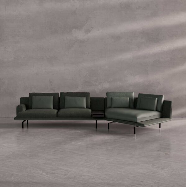"Green Renzo sofa with decorative cushion and black marble side table – luxury living room furniture UAE." "أريكة رينزو باللون الأخضر مع وسادة ديكور وطاولة جانبية من الرخام الأسود – أثاث غرفة معيشة فاخرة في الإمارات."