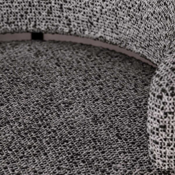 Close-up of Vireo Lounge Chair upholstered in textured fabric with sculpted curved backrest – premium designer chair in Dubai. لقطة قريبة لكرسي فيريو بقماش منسوج فاخر مع مسند ظهر منحني – كرسي مصمم راقٍ في دبي.