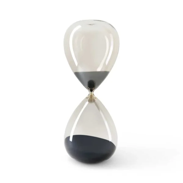 Elegant glass hourglass décor with sleek curved design and black sand, modern minimalist accessory for luxury UAE homes and offices.