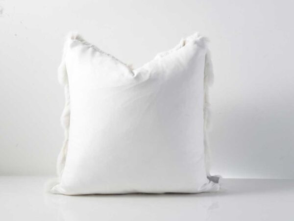 Back view of Lysva Cushion with smooth white cotton finish complementing the soft fur front
