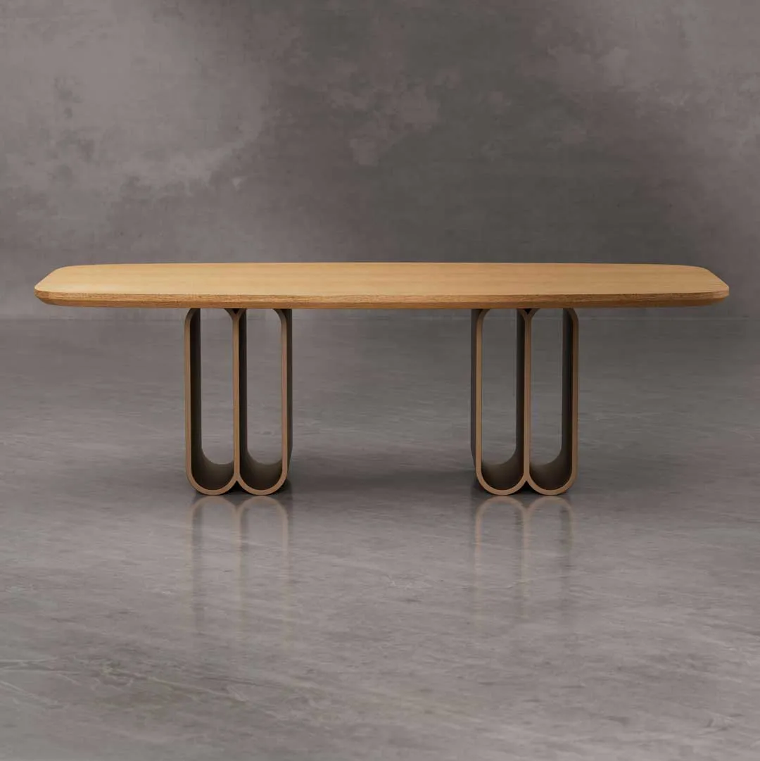 Olenza Dining Table with smooth oak top and sculptural brushed brass base — luxury modern dining table for elegant interiors in Dubai and Abu Dhabi, UAE.