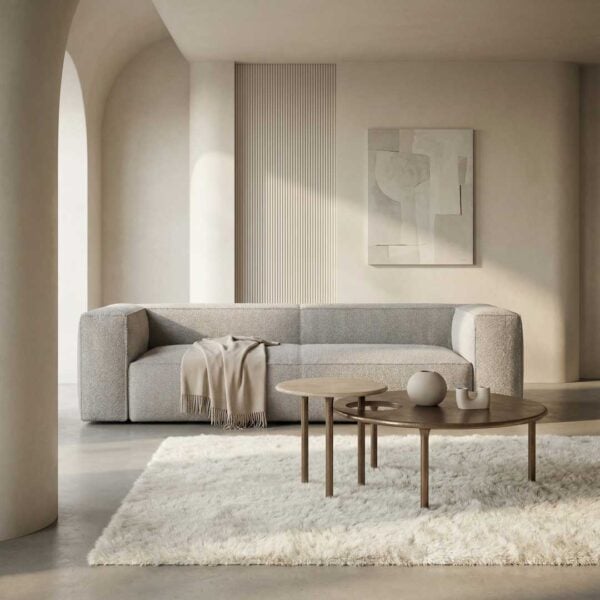 Luxury minimalist nesting coffee tables in a modern Dubai living room, featuring sleek wooden tops and elegant sculpted legs, styled alongside a premium contemporary sofa and soft neutral décor for an elevated interior aesthetic