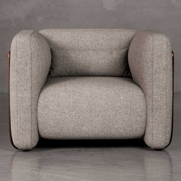 Front view of Cove sculptural lounge chair with thick rounded arms, deep seat cushion, and architectural form in premium woven fabric, ideal for luxury villas and developer projects in Dubai and Abu Dhabi UAE.