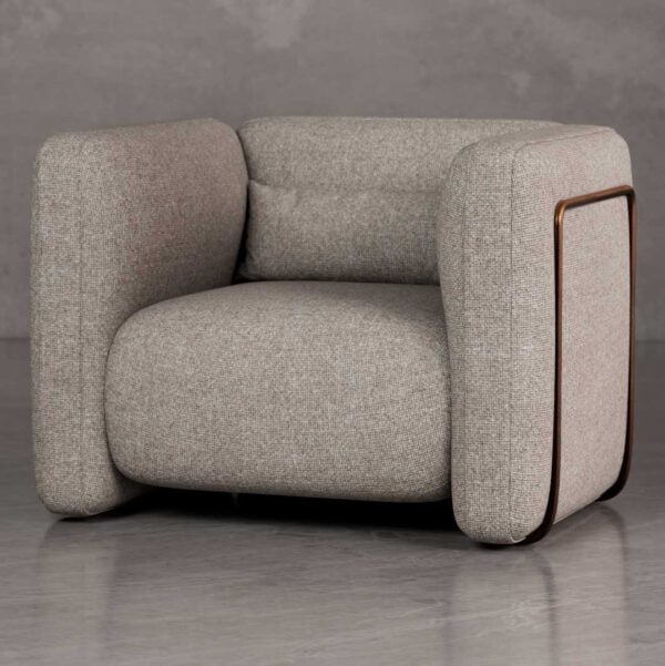 Luxury Cove lounge chair with bold rounded armrests and architectural box form in textured upholstery, a premium American designer chair for luxury real estate and developer interiors in Dubai and Abu Dhabi UAE.