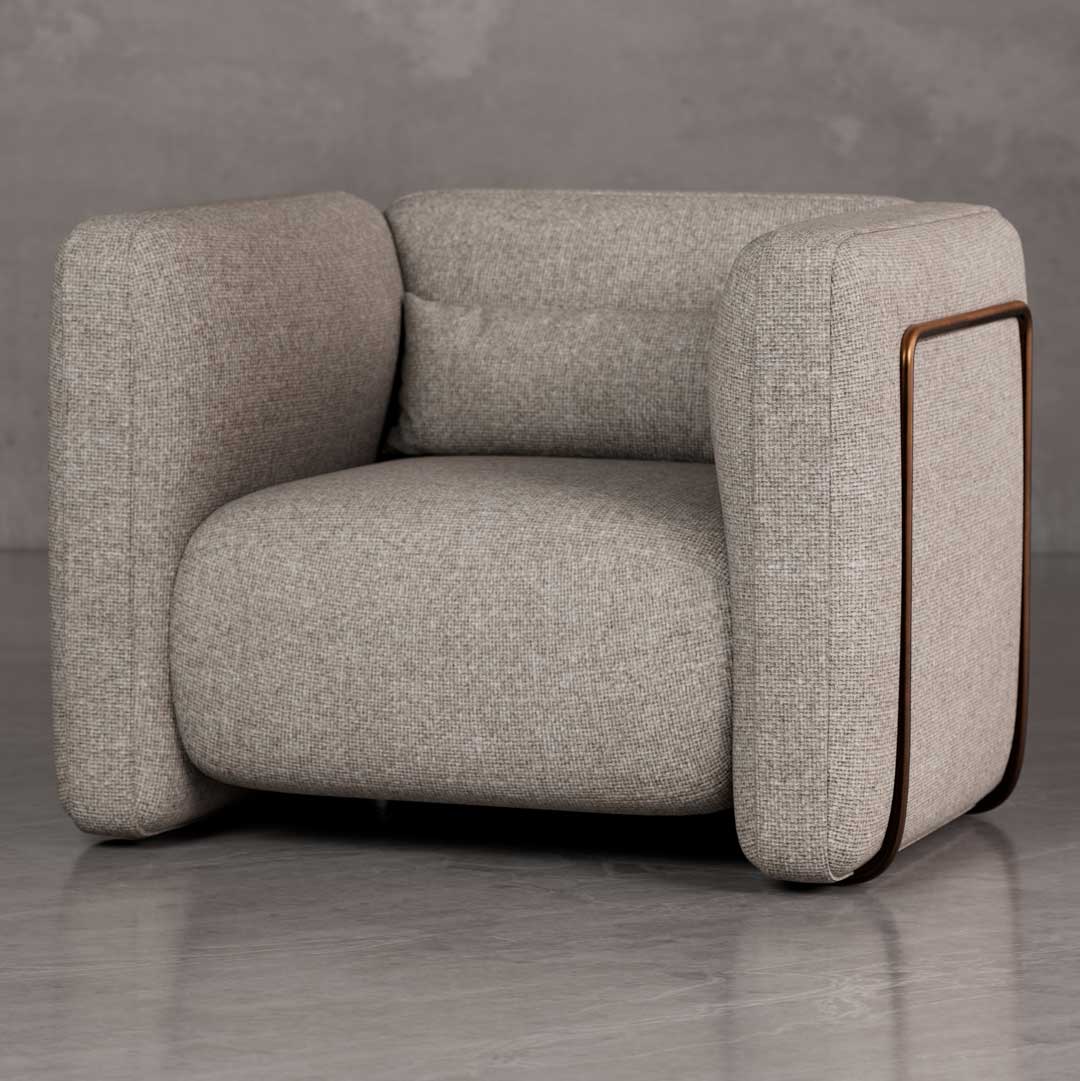 Luxury Cove lounge chair with bold rounded armrests and architectural box form in textured upholstery, a premium American designer chair for luxury real estate and developer interiors in Dubai and Abu Dhabi UAE.