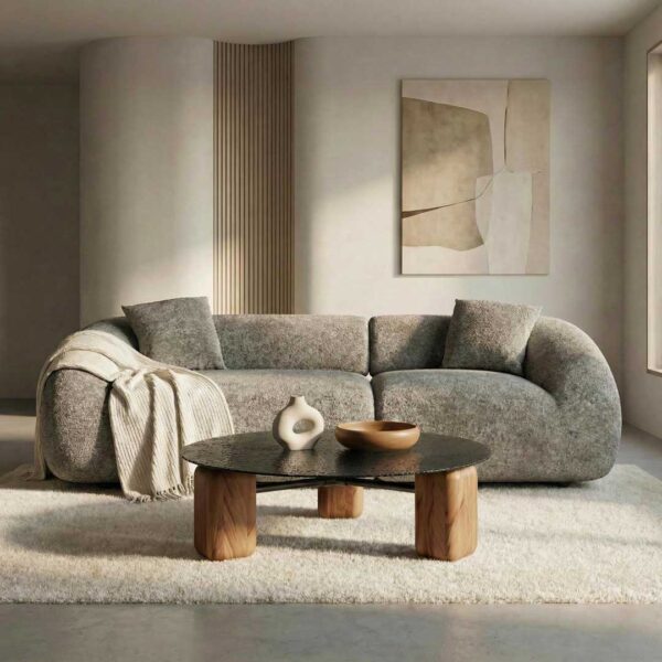Luxury curved 3-seater bouclé sofa with an organic sculptural silhouette and rounded arms, styled in a modern minimalist living room with a wooden coffee table and neutral decor, designed for upscale interiors in Dubai and Abu Dhabi UAE.